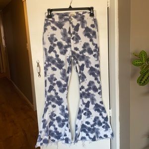 Tie dye stretch high wasted flare jeans. Rough cut hem.